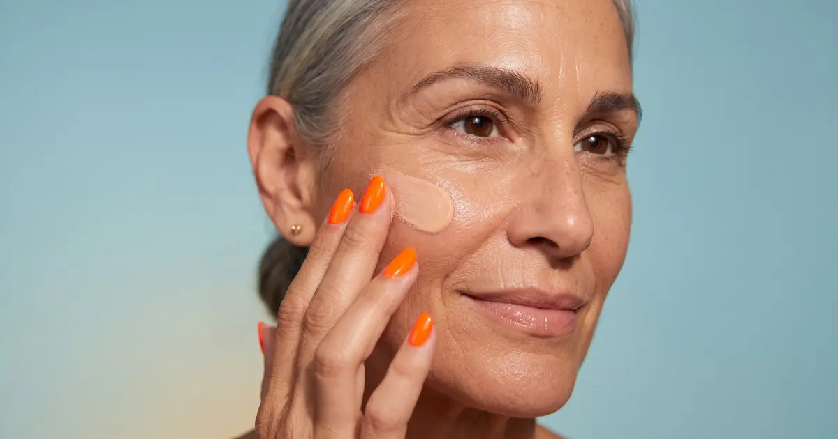 Woman in her 50s applying skin tint